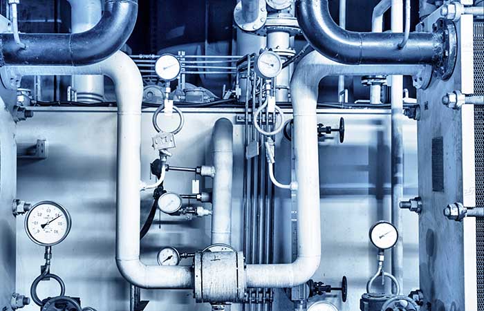 Equipment, cables and piping as found inside of industrial power plant