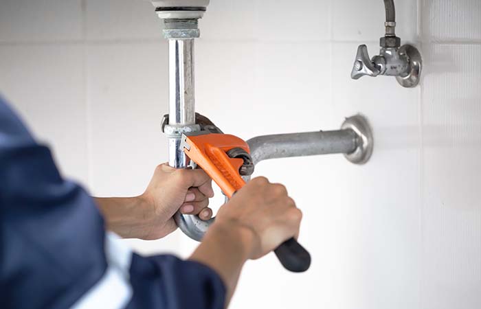 plumber at work in a bathroom, plumbing repair service, assemble