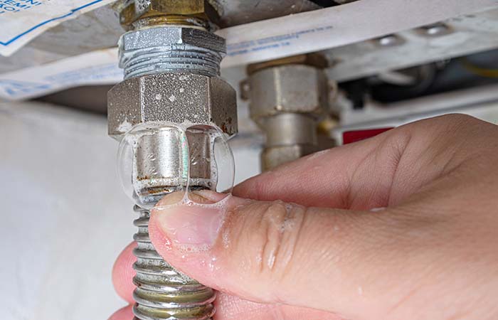 Gas leak at home boiler room. Inflating bubbles of soap mixture